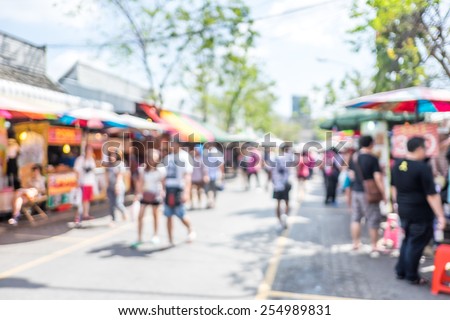 Blurred background : people shopping at market fair in sunny day, blur background with bokeh