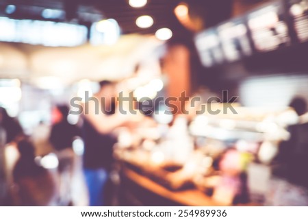 Blurred background : Vintage filter Customer at counter in Coffee shop blur background with bokeh