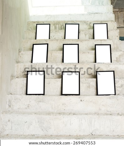 Group of black photo frames on rough concrete stair at building,Template mock up for adding your picture.