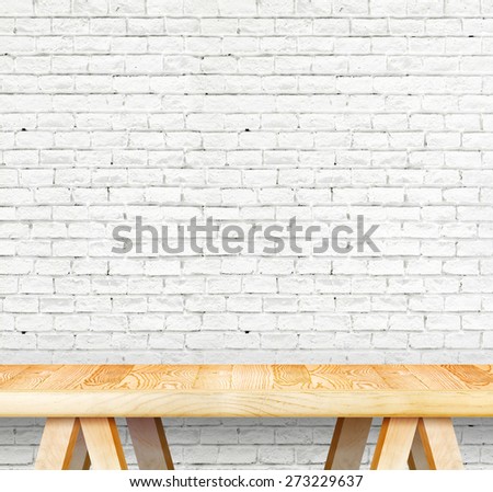 Empty wood modern table and grunge white brick wall in background,Mock up template for display of your product.