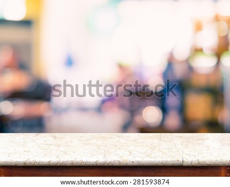 Empty marble table top and blurred coffee shop bokeh light in background, Mock up for display of product