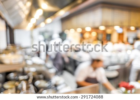 Blurred background : Groups of Chef cooking in the open kitchen,customer can see they cooking at food counter, cooking chef with light bokeh.