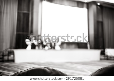 Black and white Blurred background : Speaker on stage in seminar convention hall.