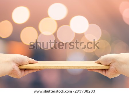 Two hand holding food plate made from wood with bokeh light background, Template mock up for adding your product and leave space for adding content ,