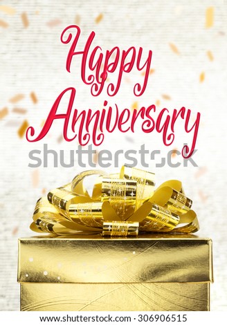 Close up Golden present box with Happy Anniversary word and confetti blur background.