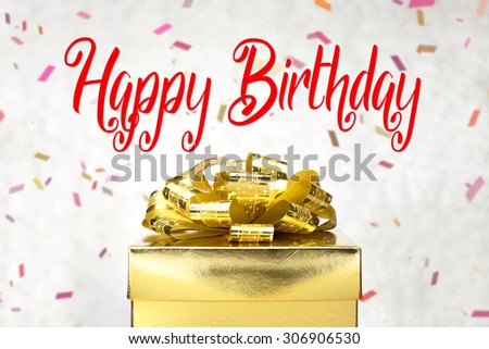 Close up Golden present box with Happy Birthday word and confetti blur background.