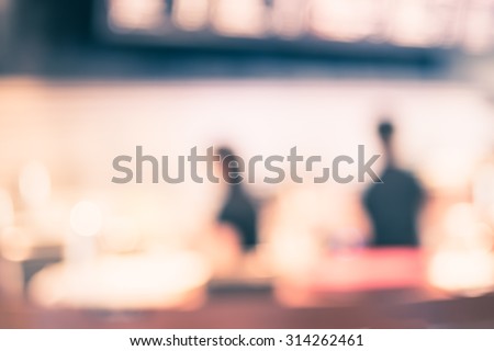 Blurred background : Vintage filter ,Coffee bar with barista at counter in cafe.