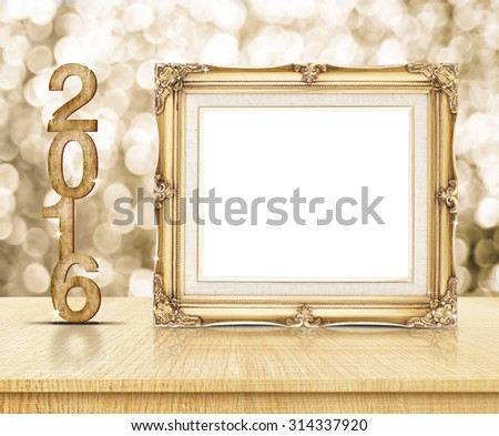 Golden Vintage frame with 2016 year wood texture with sparkling gold bokeh wall and wooden table.
