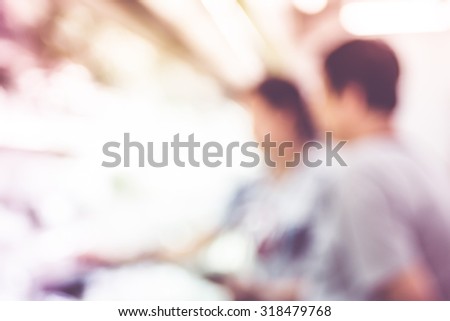 Blurred background : Customer select food product on shelf at Supermarket with bokeh light