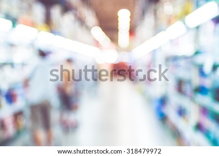 Blurred background : Customer at supermarket product shelf with bokeh light