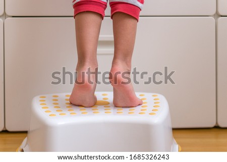 Image, Stock Photo Baby reaching for feet, dimpled baby hands, triangle print blanket and pants