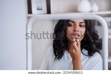 Similar – Image, Stock Photo Woman applying lipstick and looking in side mirror of bus