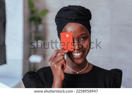 Similar – Image, Stock Photo Confident ethnic lady covering eye with hand in red studio