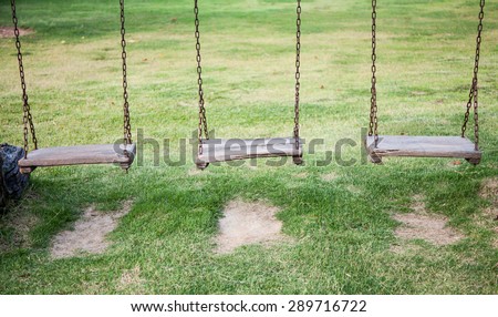 three swing in green garden