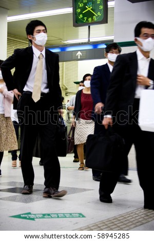 KOBE, JAPAN - MAY 20: People at the station wear face masks because of the outbreak of swine flu near Sannomiya JR station May 20, 2009 in Kobe, Japan.