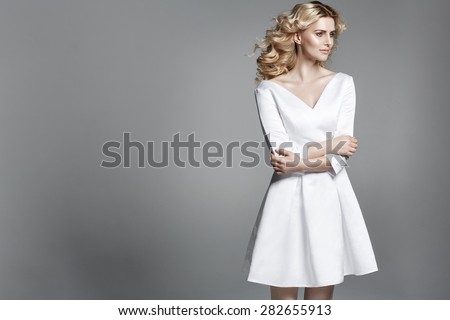 Smart blond lady wearing white dress
