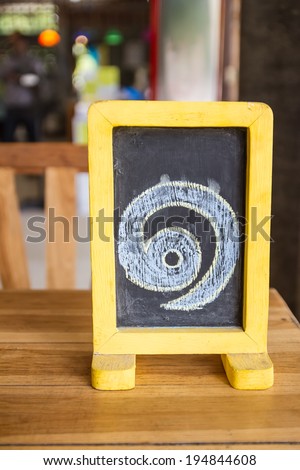 Small blackboard with Thai number written, standing on the table
