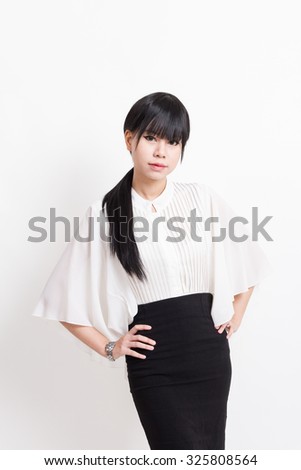 asian business woman with arms akimbo isolated on white background