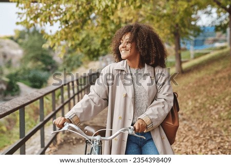 Similar – Image, Stock Photo Ethnic woman with bicycle on street