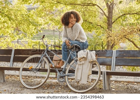 Similar – Image, Stock Photo Ethnic woman with bicycle on street