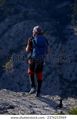 Image, Stock Photo Unrecognizable hiker observing wild valley from rocky cliff