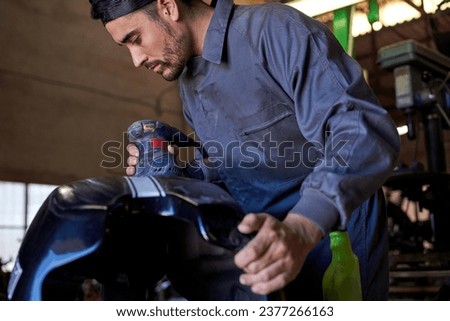 Similar – Image, Stock Photo Busy technician in motorcycle workshop