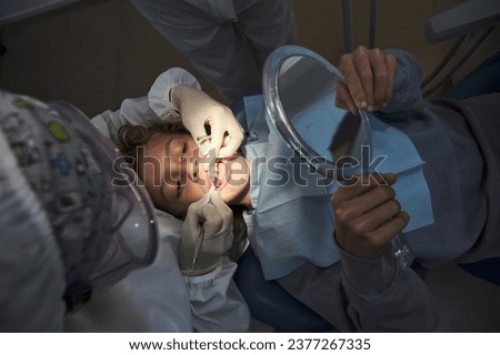 Similar – Image, Stock Photo Anonymous dentist checking teeth of patient