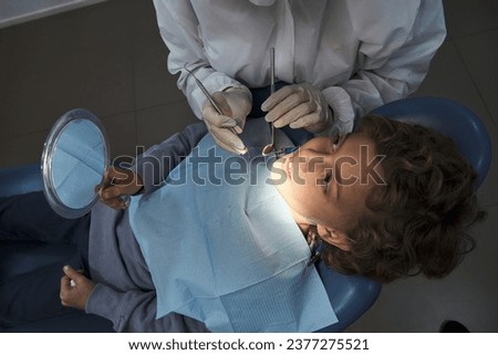 Similar – Image, Stock Photo Crop dentist examining teeth of patient in clinic