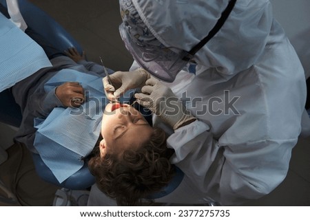 Similar – Image, Stock Photo Anonymous dentist checking teeth of patient