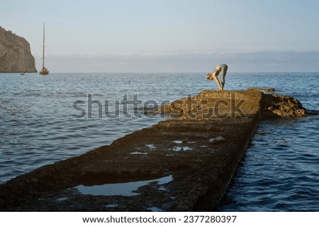 Similar – Image, Stock Photo Anonymous sportswoman practicing yoga on street