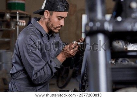 Similar – Image, Stock Photo Busy technician in motorcycle workshop