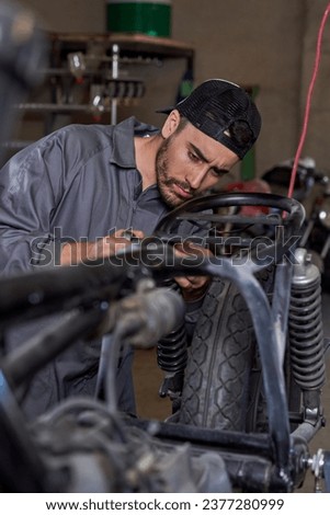 Similar – Image, Stock Photo Busy technician in motorcycle workshop