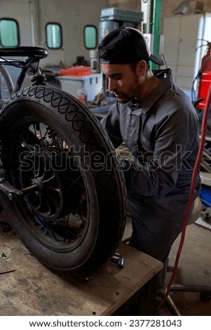 Similar – Image, Stock Photo Busy technician in motorcycle workshop