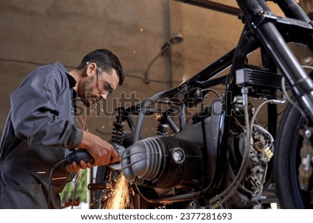 Similar – Image, Stock Photo Busy technician in motorcycle workshop