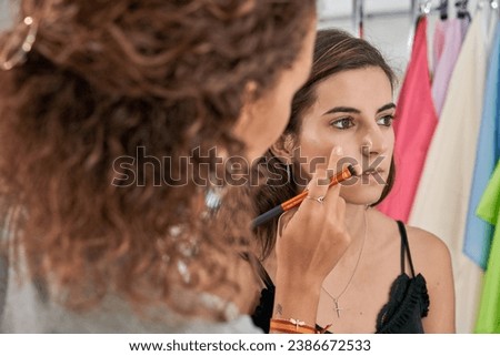 Similar – Image, Stock Photo Professional visagiste applying powder on model face