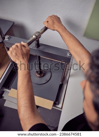 Similar – Image, Stock Photo Unrecognizable handyman using machine on factory