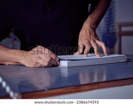 Similar – Image, Stock Photo Craftsman working with book and paper knife