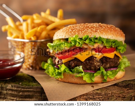 
Hamburger and fried potatoes on a wooden table