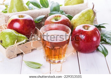 Fresh organic apples and pears and fresh juice over white wooden background