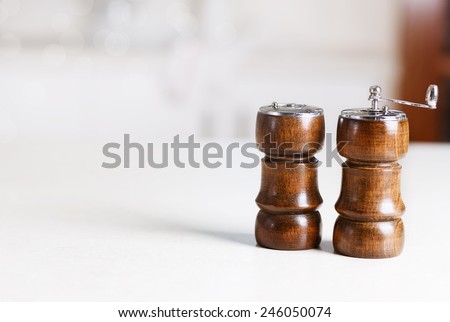Kitchen background. Pepper shaker and pepper mill on a kitchen counter surface