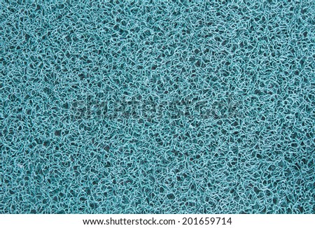 Background of pallid blue carpet or foot scraper or door mat texture