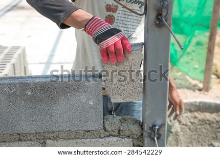 Close-up of construction process mason work with brick