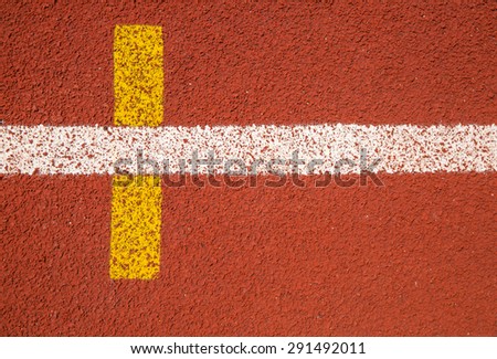 white and yellow line on red track texture background
