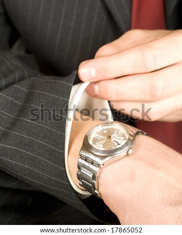 business man checking the time on his watch