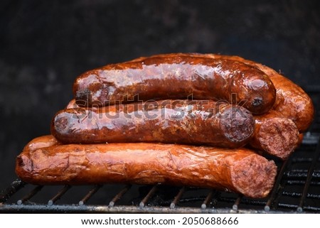 Delicious sausages on the grill, ingredients, homemade meal, dish, food, fat, grass, high caloric, fire, fireplace, wood, gas oven, crispy, pepper, hungarian, smoke, baking, pepperoni,burnt, spicy  Foto stock © 