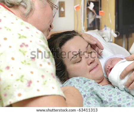Mother and grandmother with newborn baby right after delivery