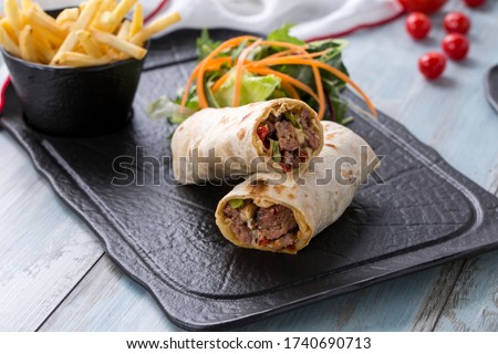 beef wrap , beef burrito beef roll, lamb wrap , lamb burrito lamb roll  on the wooden background