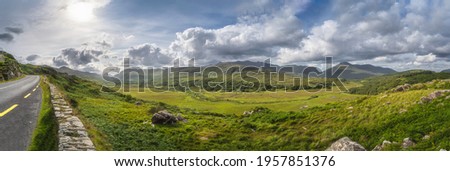 Large panorama with road in Molls Gap, Owenreagh River valley, MacGillycuddys Reeks mountains and farms, Wild Atlantic Way, Ring of Kerry, Ireland Stok fotoğraf © 