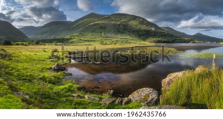 Large panorama with sunken paddle boats in Lough Gummeenduff. Beautiful Black Valley at sunset, MacGillycuddys Reeks mountains, Ring of Kerry, Ireland Stok fotoğraf © 