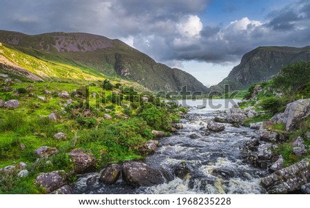 Beautiful landscape with mountain river flowing from Black Lake in Gap of Dunloe. Green hills at sunset in Black Valley, MacGillycuddys Reeks mountains, Ring of Kerry, Ireland Stok fotoğraf © 